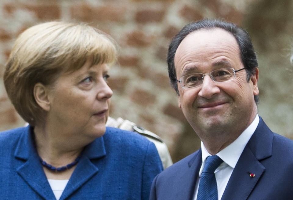 Chancellor Angela Merkel, left, and French President Francois Hollande walk through the old town of Stralsund, northern Germany, Saturday, May 10, 2014 during the second day of Hollande's two days visit to Merkel's scenic home constituency on the Baltic coast . One of the main talking points is expected to be over whether the European Union should impose further sanctions on Russia, for its involvement in the Ukraine crisis. (AP Photo/Gero Breloer)