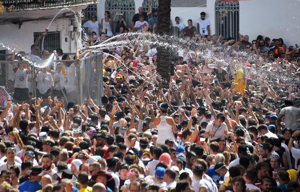People hose off participants in front of the Town Hall taking part in the annual "Tomatina" festival. The iconic fiesta, which is billed as "the world's biggest food fight" has become a major draw for foreigners, in particular from Britain, Japan and the United States.