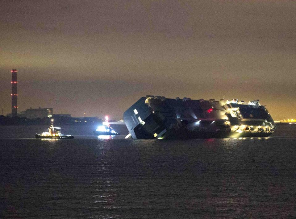 The cargo ship Hoegh Osaka lies on its side after running aground on Saturday evening in the Solent estuary, near Southampton in southern England