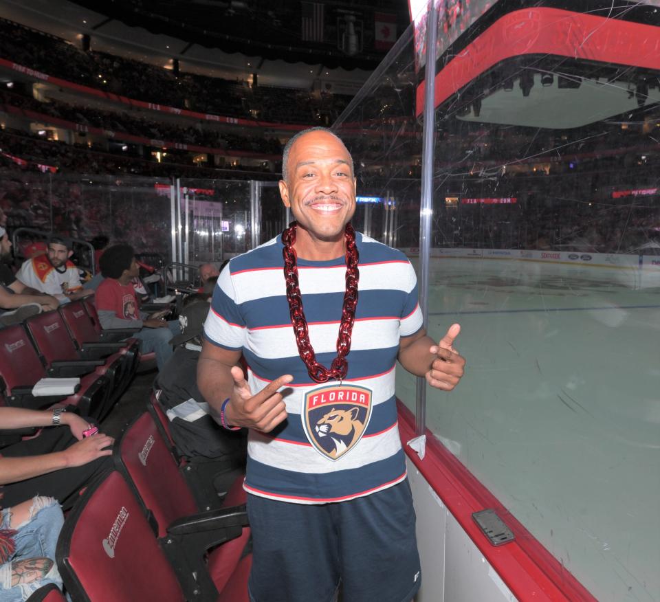 Florida Panthers fan Bill Showell poses in front of the ice-level seats while watching Game 6 between the Panthers and Edmonton Oilers at the Amerant Bank Arena watch party (June 21, 2024).