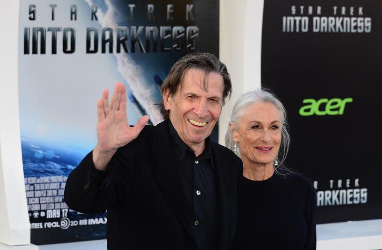 Leonard Nimoy, who played the role of 'Spock' in the Star Trek TV and film franchise, gives the famous 'Vulcan' greeting next to his wife at the Los Angeles premiere of the movie 'Star Trek Into Darkness" in Hollywood, California on May 14, 2013