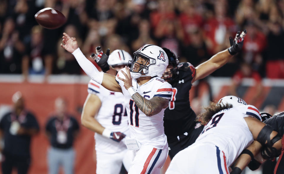 SALT LAKE CITY, UT – SEPTEMBER 28: Noah Fifita #11 of the Arizona Wildcats throws under pressure from the Utah Utes during the first half of their game at Rice Eccles Stadium on September 28, 2024 in Salt Lake City, Utah. (Photo by Chris Gardner/Getty Images)