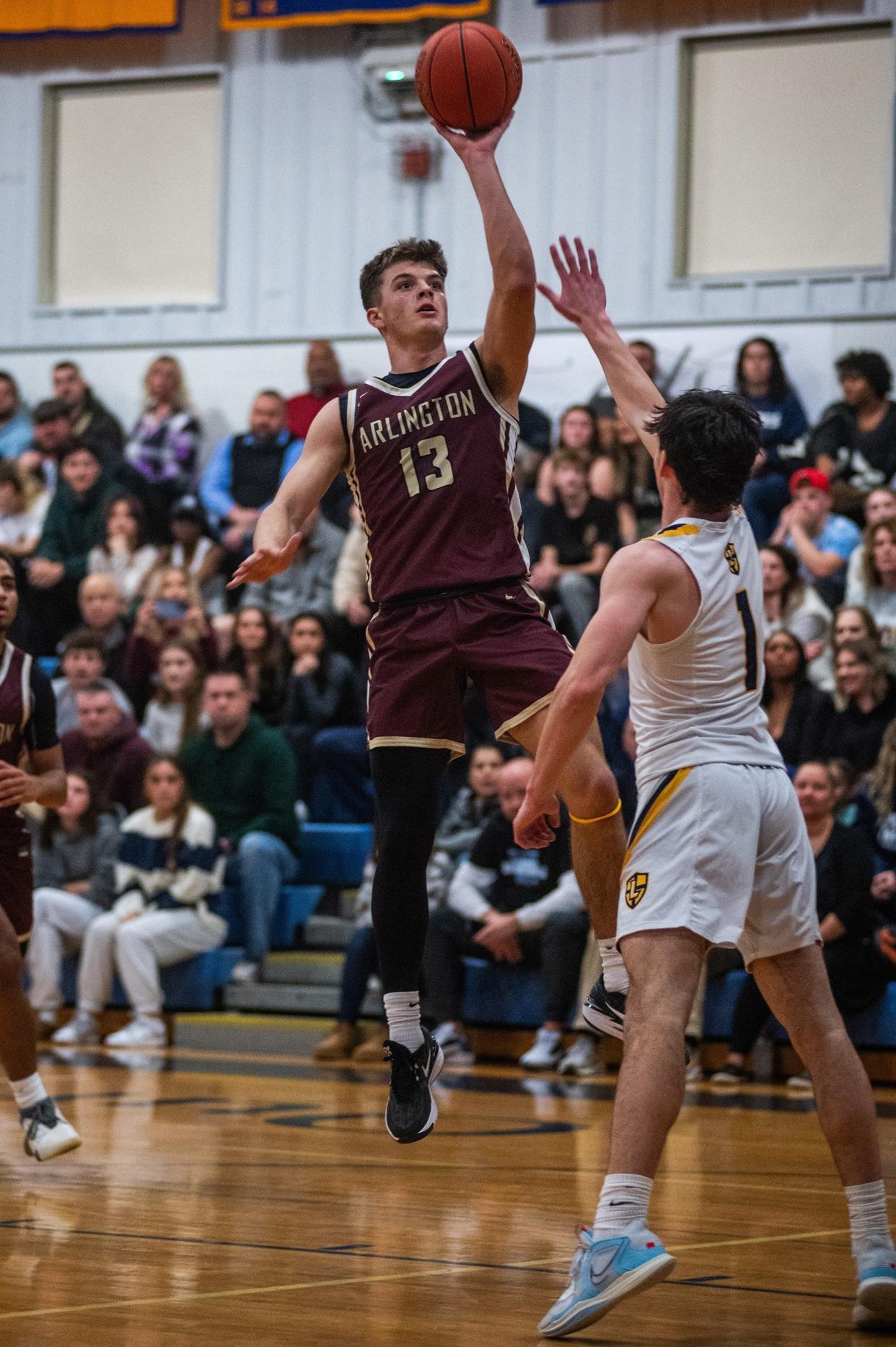 Arlington's Mike Rescigno goes up for a floater against Lourdes' Mike Sabini during the final of the Duane Davis Memorial basketball tournament on Dec. 29, 2023.