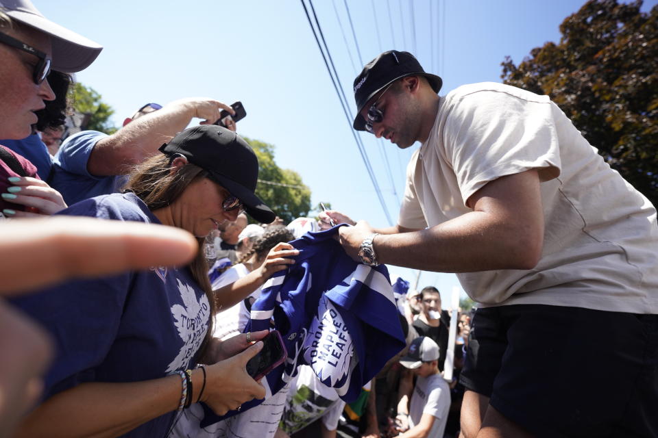 NHL player Nazem Kadri signs autographs in front of the London Muslim Mosque in London, Ontario as he brings the Stanley Cup to his hometown on Saturday Aug. 27, 2022. Kadri, 31, won the cup for the first time while playing with the Colorado Avalanche. (Geoff Robins /The Canadian Press via AP)