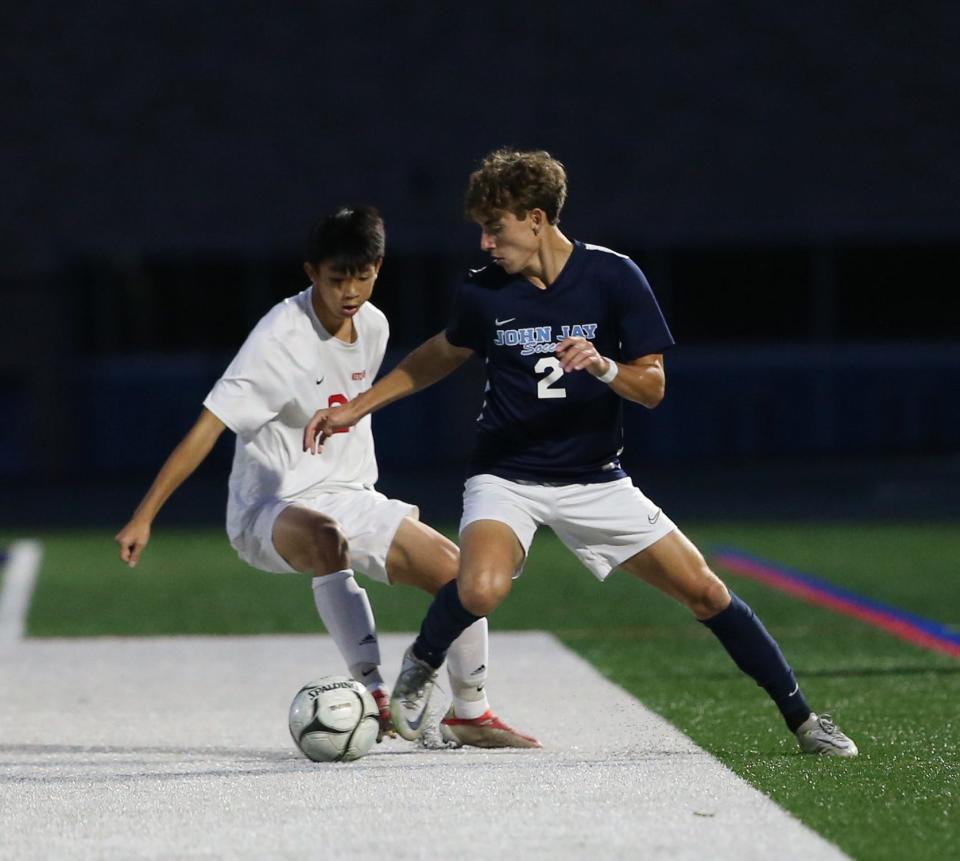 John Jay's Erik Popp challenges Roy C. Ketham's Dylan Minyanou during Tuesday's boys soccer game on September 20, 2022. 