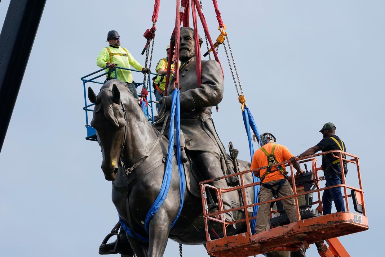 Crews prepare to remove one of the country's largest remaining monuments to the Confederacy, a towering statue of Confederate General Robert E. Lee on Monument Avenue, Sept. 8, 2021 in Richmond, Virginia. 