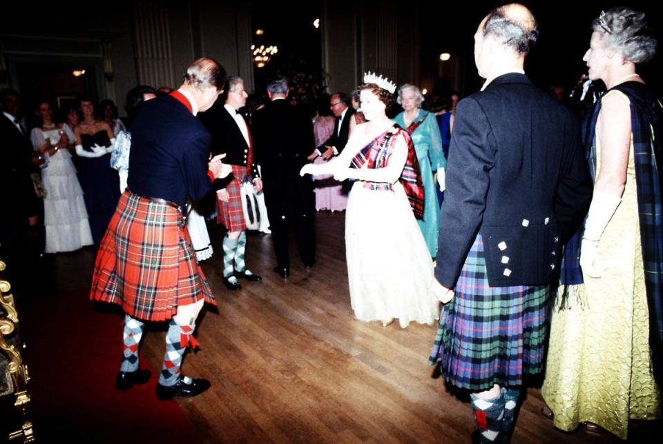 Queen Elizabeth II, takes to the floor with the Duke of Edinburgh during the Centenary Ball of the Scottish Pipers’ Society at the Assembly Room, Edinburgh (PA) (PA Archive)
