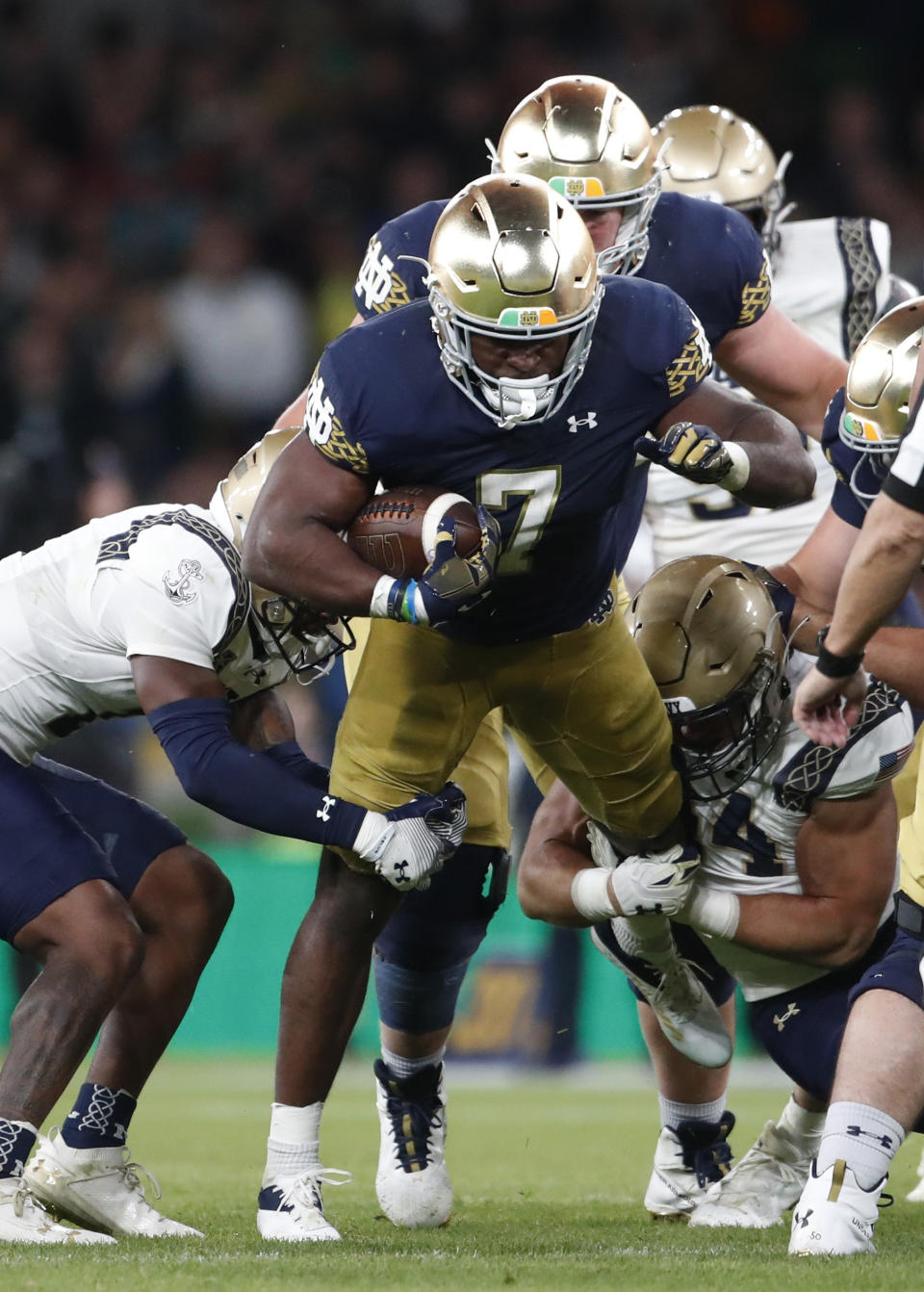 Notre Dame running back Audric Estime (7) is stopped on a run against Navy during the second half of an NCAA college football game in Dublin, Ireland, Aug. 26, 2023. (AP Photo/Peter Morrison)