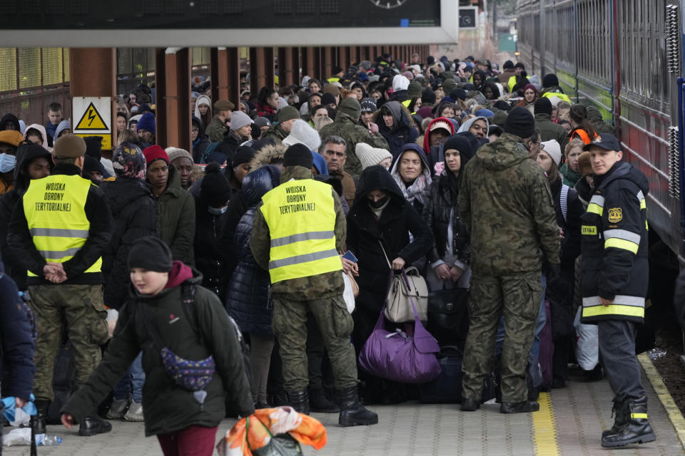 FILE - Refugees from Ukraine arrive at the railway station in Przemysl, Poland, Feb. 27, 2022. Nearly a year has passed since the Feb. 24, 2022, invasion sent millions of people fleeing across Ukraine's border into neighboring Poland, Slovakia, Hungary, Moldova and Romania. (AP Photo/Czarek Sokolowski, File)