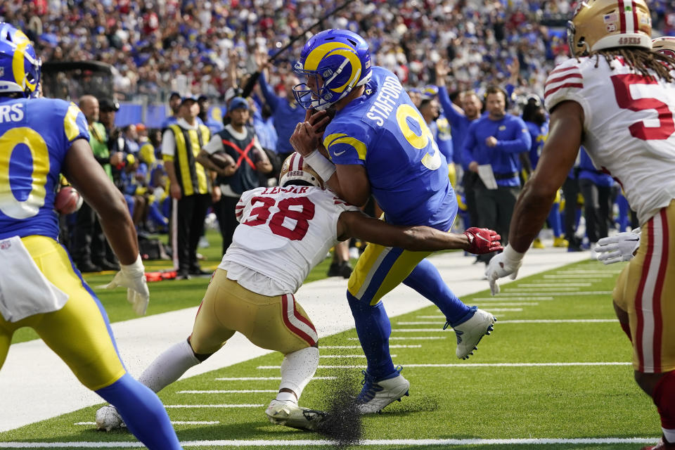 Los Angeles Rams quarterback Matthew Stafford (9) gets in for a touchdown as San Francisco 49ers cornerback Deommodore Lenoir attempts a tackle during the first half of an NFL football game Sunday, Oct. 30, 2022, in Inglewood, Calif. (AP Photo/Gregory Bull)