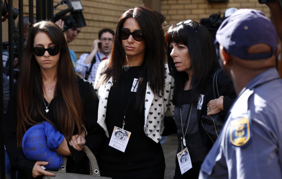 Friends of the late Reeva Steenkamp leave after the trial of Olympic and Paralympic track star Oscar Pistorius for the murder of Steenkamp, at the North Gauteng High Court in Pretoria March 24, 2014. The athlete, nicknamed the "Blade Runner", is on trial for the murder of his 29-year-old girlfriend at his suburban Pretoria home on Valentine's Day last year. He has pleaded not guilty, saying he mistook Steenkamp for an intruder. REUTERS/Siphiwe Sibeko (SOUTH AFRICA - Tags: CRIME LAW SPORT ATHLETICS)