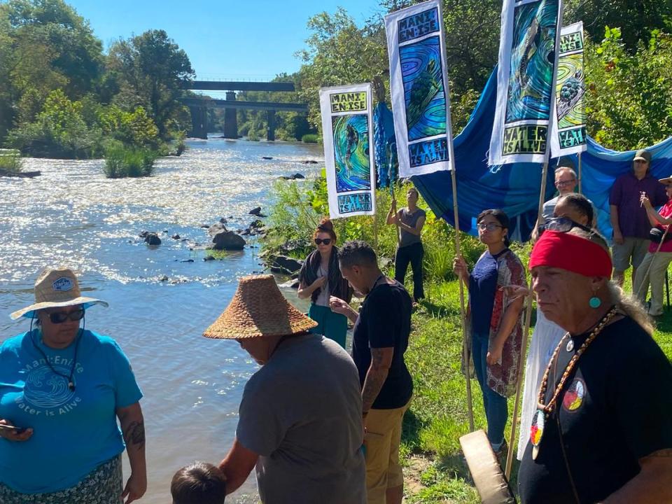 Activists with the Saponi and Lummi tribes join environmental activists for a water blessing ceremony at the Haw River.