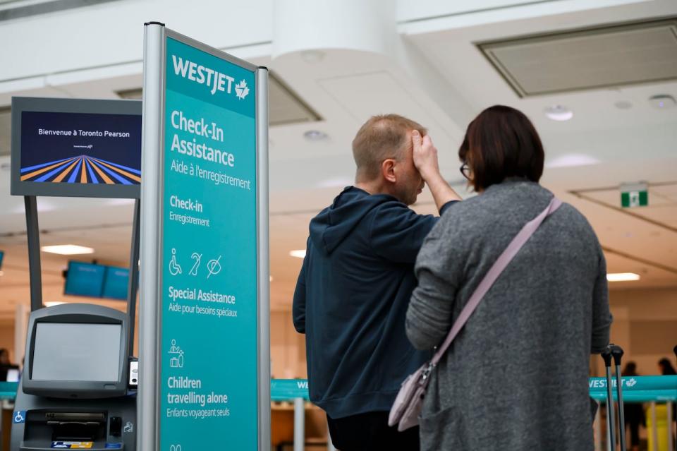 Passengers are seen in the WestJet check-in area at Pearson International Airport, in Toronto, Saturday, June 29, 2024. 