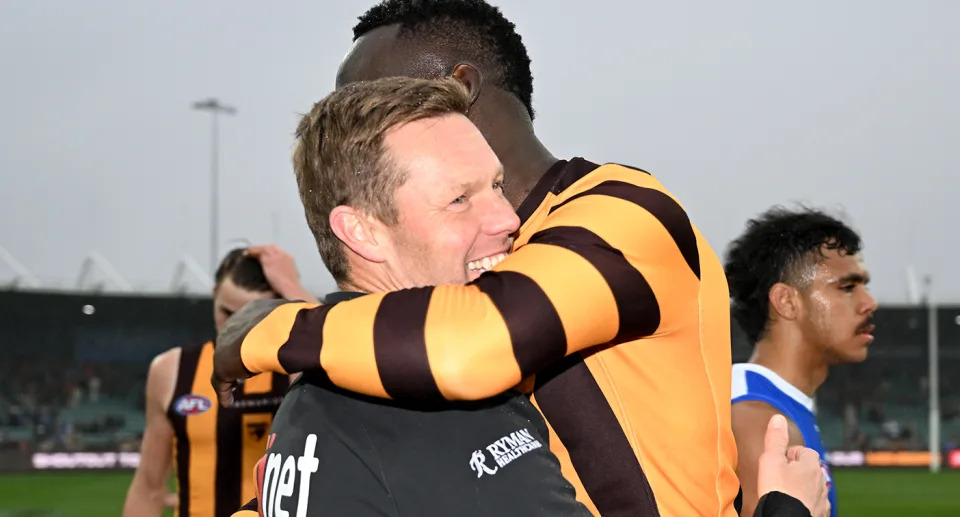 Hawthorn coach Sam Mitchell and Mabior Chol embrace after the Hawks end the season with a big win over North Melbourne and a seventh-placed finish. Pic: Getty