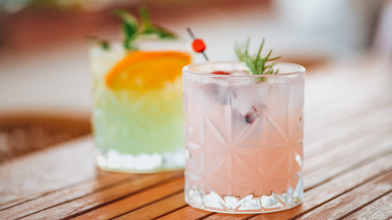 two cocktails on a wooden table