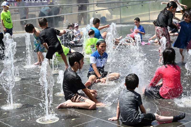 Israeli children cool off in a water fountain near Jerusalem's Old City on August 13 as temperatures in Jerusalem reached 102 degrees Fahrenheit during a scorching heat wave in Israel. File Photo by Debbie Hill/UPI