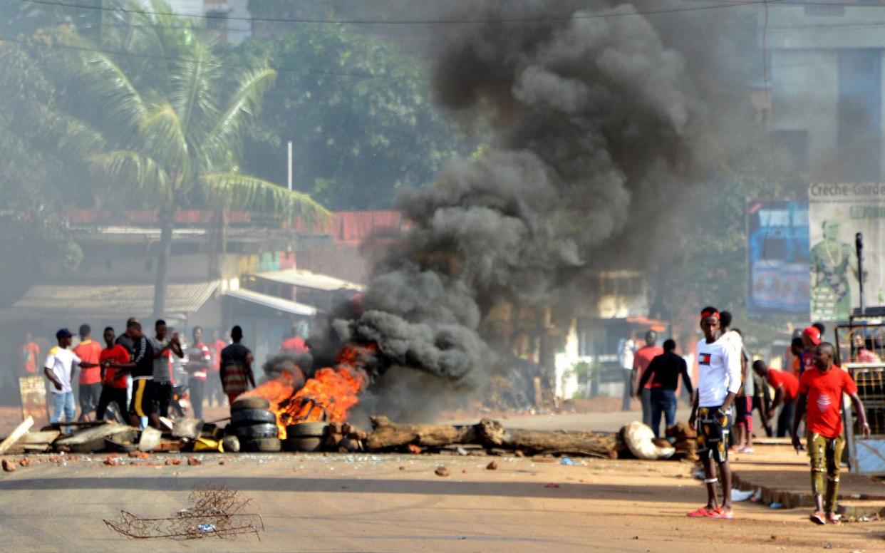 Protesters burn tyres as they demonstrate in Conakry - AFP