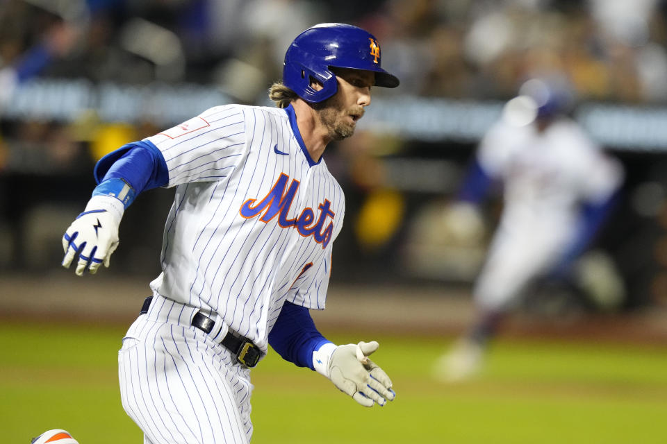 New York Mets' Jeff McNeil turns toward second base for a two-run double during the third inning of a baseball game against the San Diego Padres, Monday, April 10, 2023, in New York. (AP Photo/Frank Franklin II)