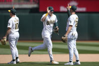 Oakland Athletics' Nick Allen, from left, celebrates with JJ Bleday and Max Schuemann after the Athletics defeated the Pittsburgh Pirates in a baseball game in Oakland, Calif., Wednesday, May 1, 2024. (AP Photo/Jeff Chiu)