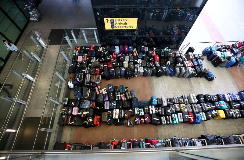 FILE PHOTO: Lines of passenger luggage lie arranged outside Terminal 2 at Heathrow Airport in London