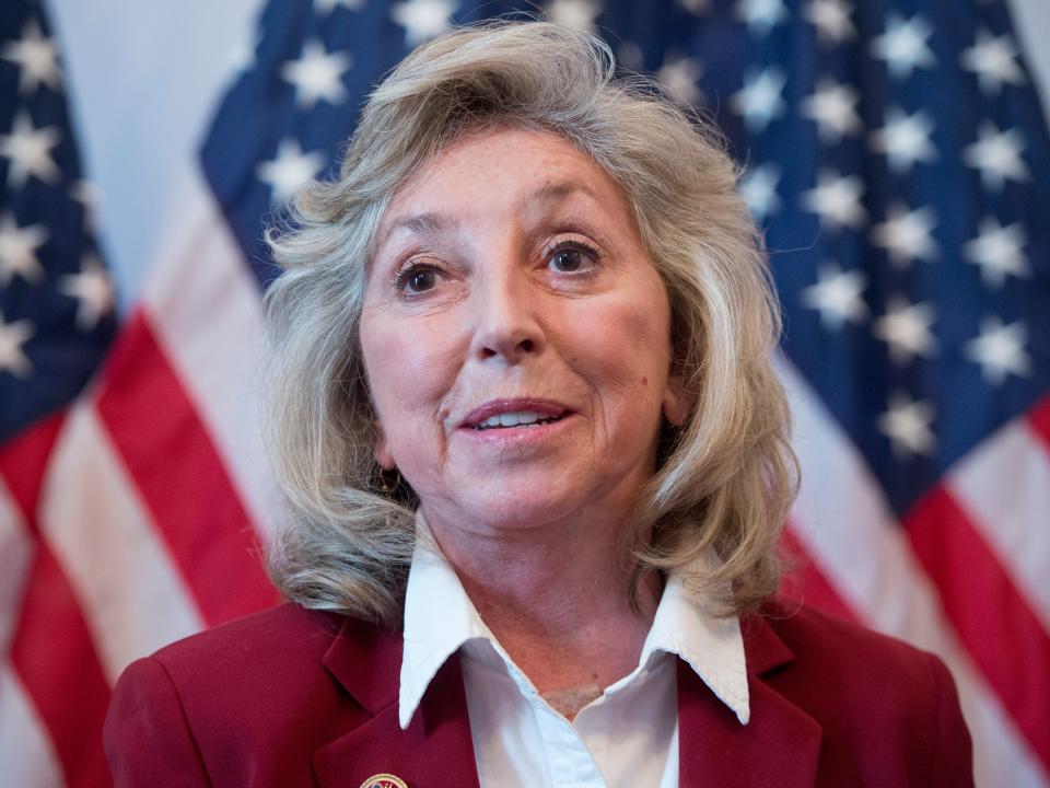 Rep Dina Titus in front of American flags