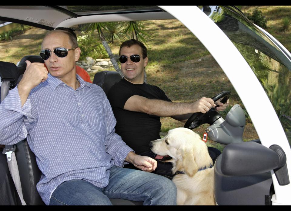 Putin, Medvedev, and a dog drive around in an electric buggy at the presidential residence in Sochi, Russia, onon Aug. 14, 2009.