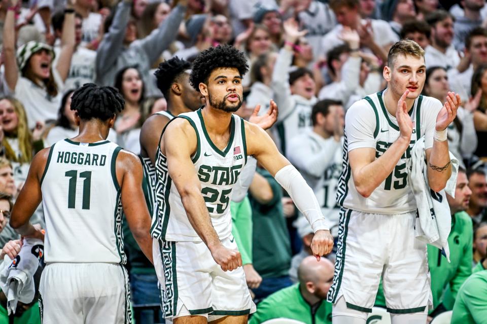 Michigan State's Malik Hall, left, and Carson Cooper, right, celebrate after Coen Carr's dunk against Rutgers during the second half on Sunday, Jan. 14, 2024, at the Breslin Center in East Lansing.
