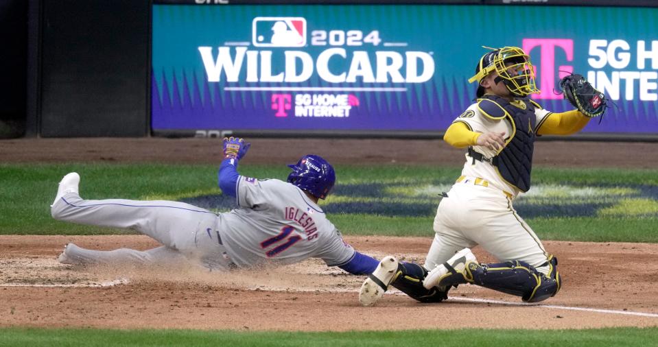 New York Mets second base Jose Iglesias (11) beats the throw to Milwaukee Brewers catcher William Contreras (24) to score during the fifth inning of their wild-card playoff game Tuesday, October 1, 2024 at American Family Field in Milwaukee, Wisconsin.