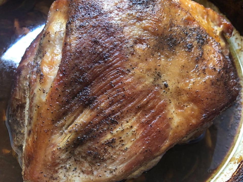 a roasted pork shoulder inside a pan