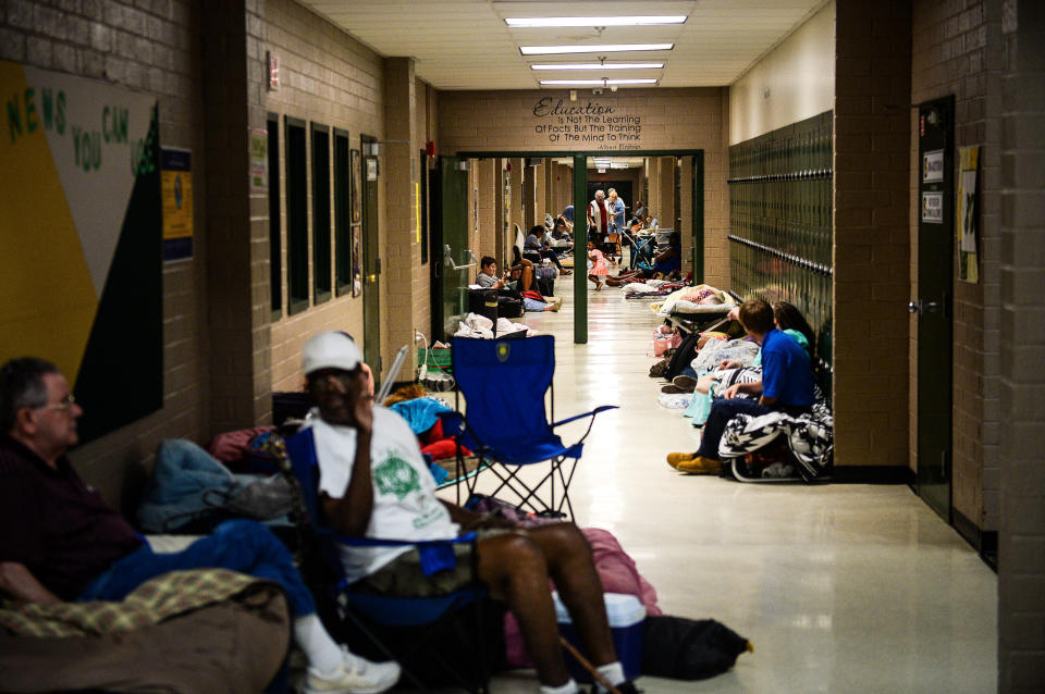 Residents sit in the hallway of a temporary Red Cross shelter at Conway High School ahead of Hurricane Florence in Conway, South Carolina. (Photo: Charles Mostoller/Bloomberg via Getty Images)