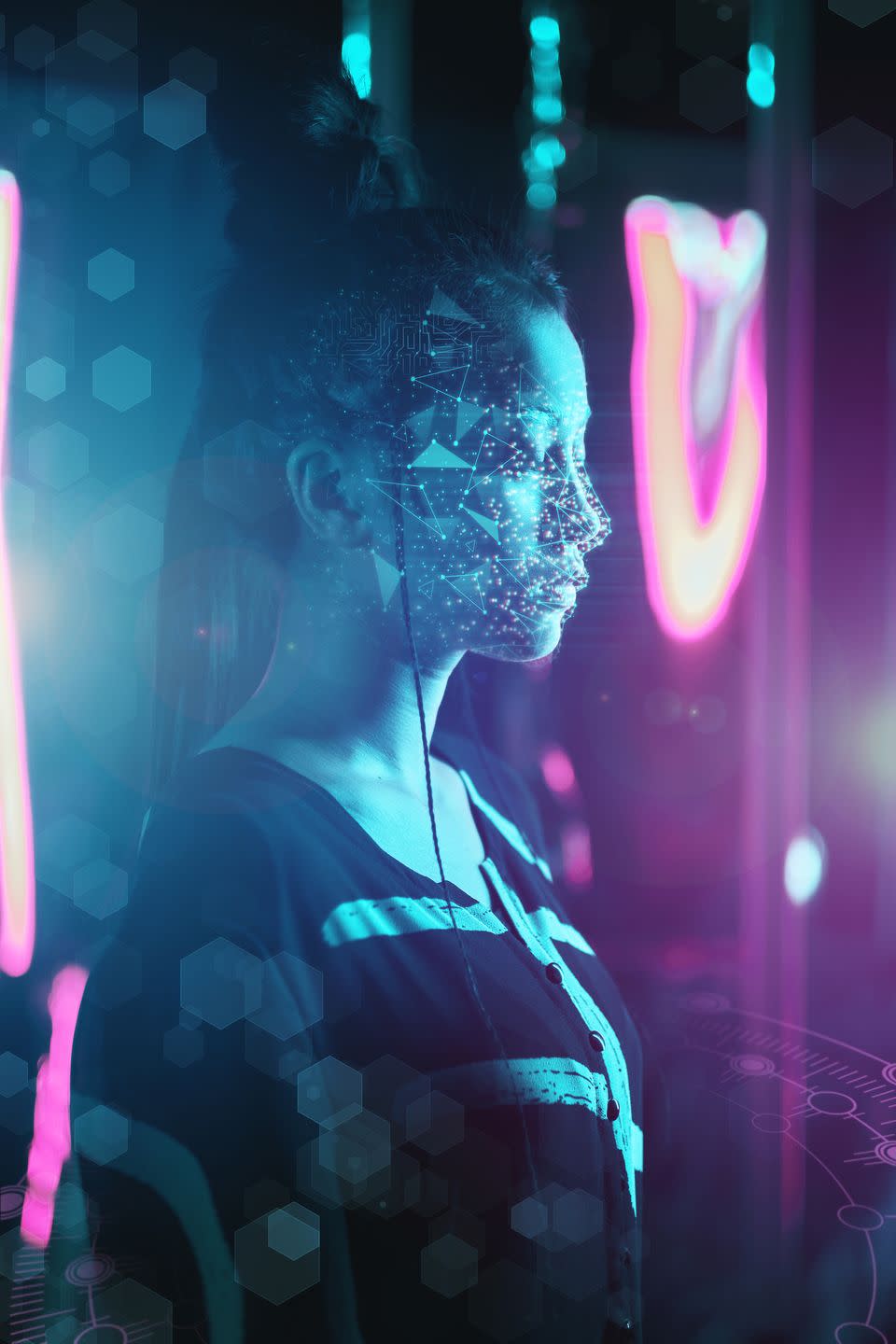 concept of a young woman being deepfaked she has ai symbols beamed onto her face