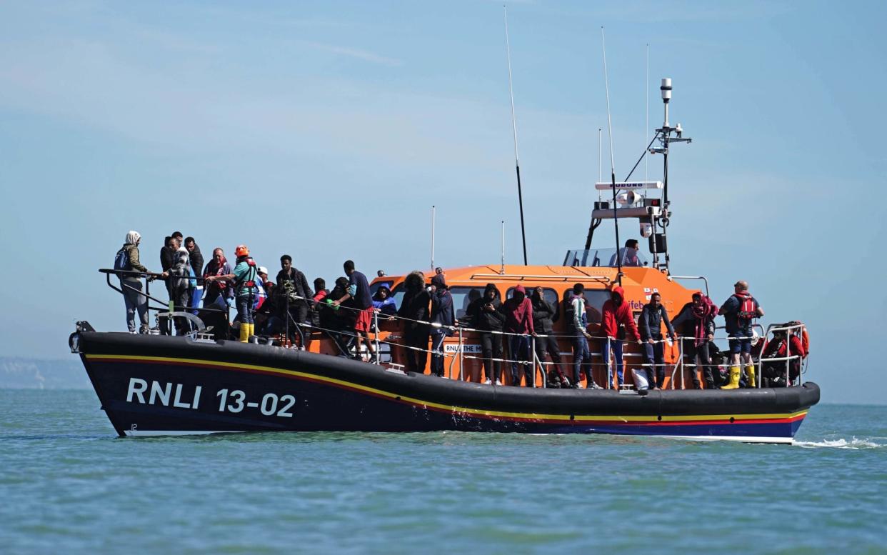 Migrants are brought in to Dungeness in Kent onboard an RNLI lifeboat — the figure for arrivals by 'small boats' last year was 40,000