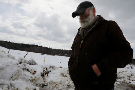 Fred Stone walks on the snow-covered pastures of his dairy farm, after discovering the soil, hay, and the milk from the cows contain extremely high levels of PFAS chemicals resulting from a 1980's state program to fertilize his pastures with treated sludge waste and making the milk unsuitable for sale, at the Stoneridge Farm in Arundel, Maine, U.S., March 11, 2019. Picture taken March 11, 2019. REUTERS/Brian Snyder