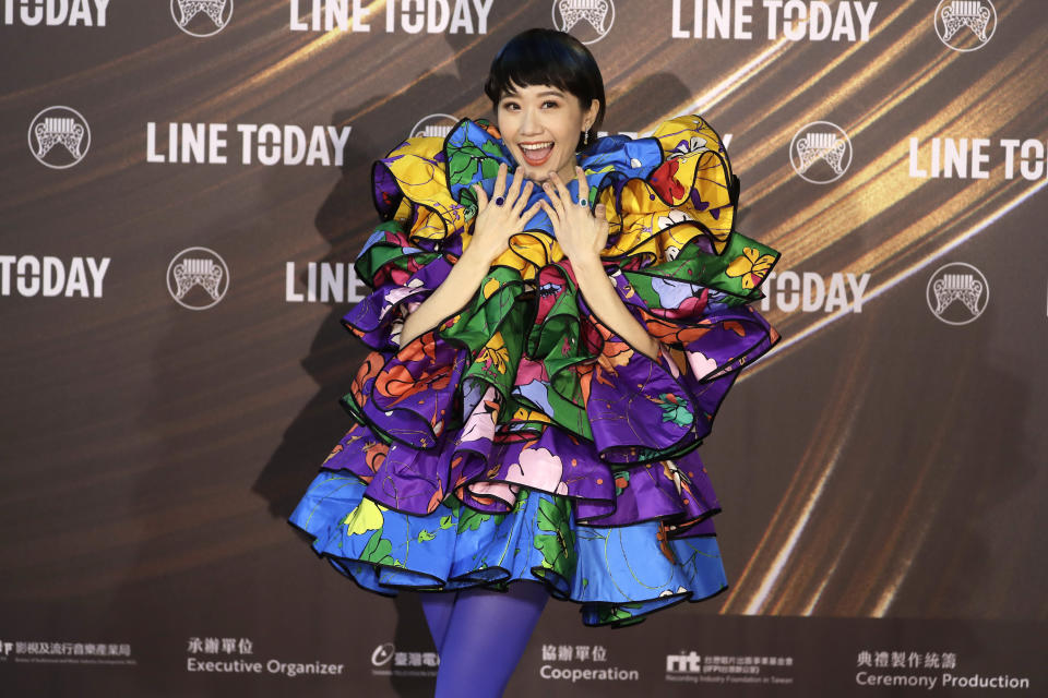 Taiwanese singer Huang Lu Tzu Yin smiles as she arrives for the 32nd Golden Melody Awards in Taipei, Taiwan, Saturday, Aug. 21, 2021. Golden Melody Awards, one of the world's biggest Chinese-language pop music annual events and postponed from June to Aug. due to the coronavirus pandemic. (AP Photo/Chiang Ying-ying)