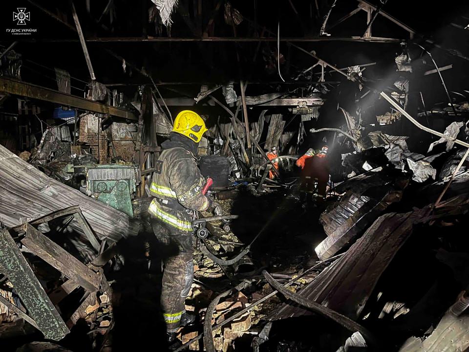 Rescuer pushing out a fire in a storage in Kyiv region, after an overnight Russian drone attack (AFP via Getty Images)