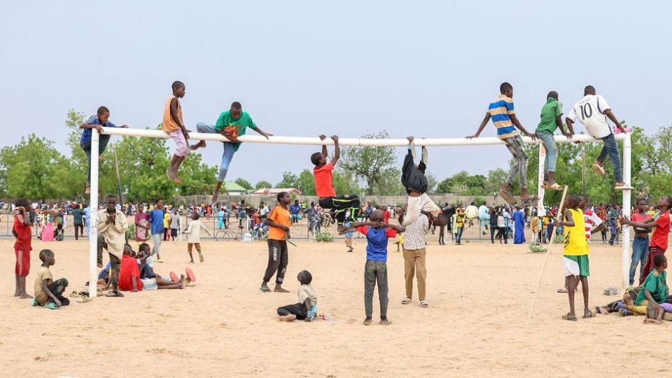 Children climb a goal post ahead of the Cameroon International Grand Prix in Maroua, Cameroon - Saturday 11 May 2024
