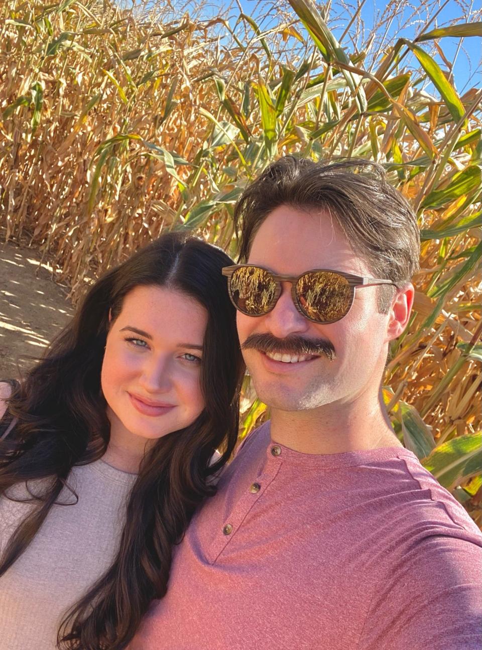 A selfie with a man and a woman in a cornfield.