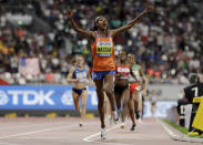 Sifan Hassan of the Netherlands celebrates after winning the gold medal in the the women's 1500 meter final at the World Athletics Championships in Doha, Qatar, Saturday, Oct. 5, 2019. (AP Photo/Petr David Josek)