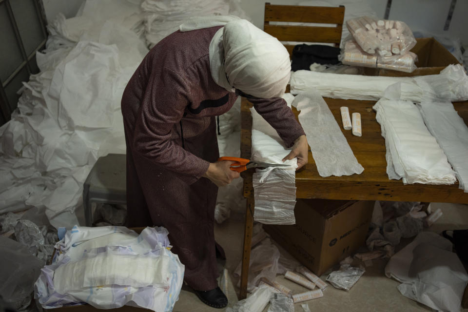 A Palestinian woman sews diapers in Rafah, southern Gaza Strip, Thursday, Feb. 15, 2024. Palestinians in Gaza have experienced severe shortages of basic necessities since the war began on Oct. 7. (AP Photo/Fatima Shbair)