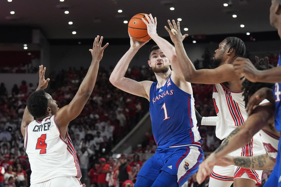 Kansas' Hunter Dickinson (1) looks to shoot as Houston's L.J. Cryer (4) and J'Wan Roberts defend during the first half of an NCAA college basketball game Saturday, March 9, 2024, in Houston. (AP Photo/David J. Phillip)