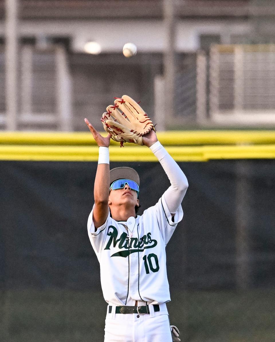 El Diamante's Aden Robles takes a hit ball in the outfield against Redwood in an East Yosemite League high school baseball game Wednesday, March 13, 2024