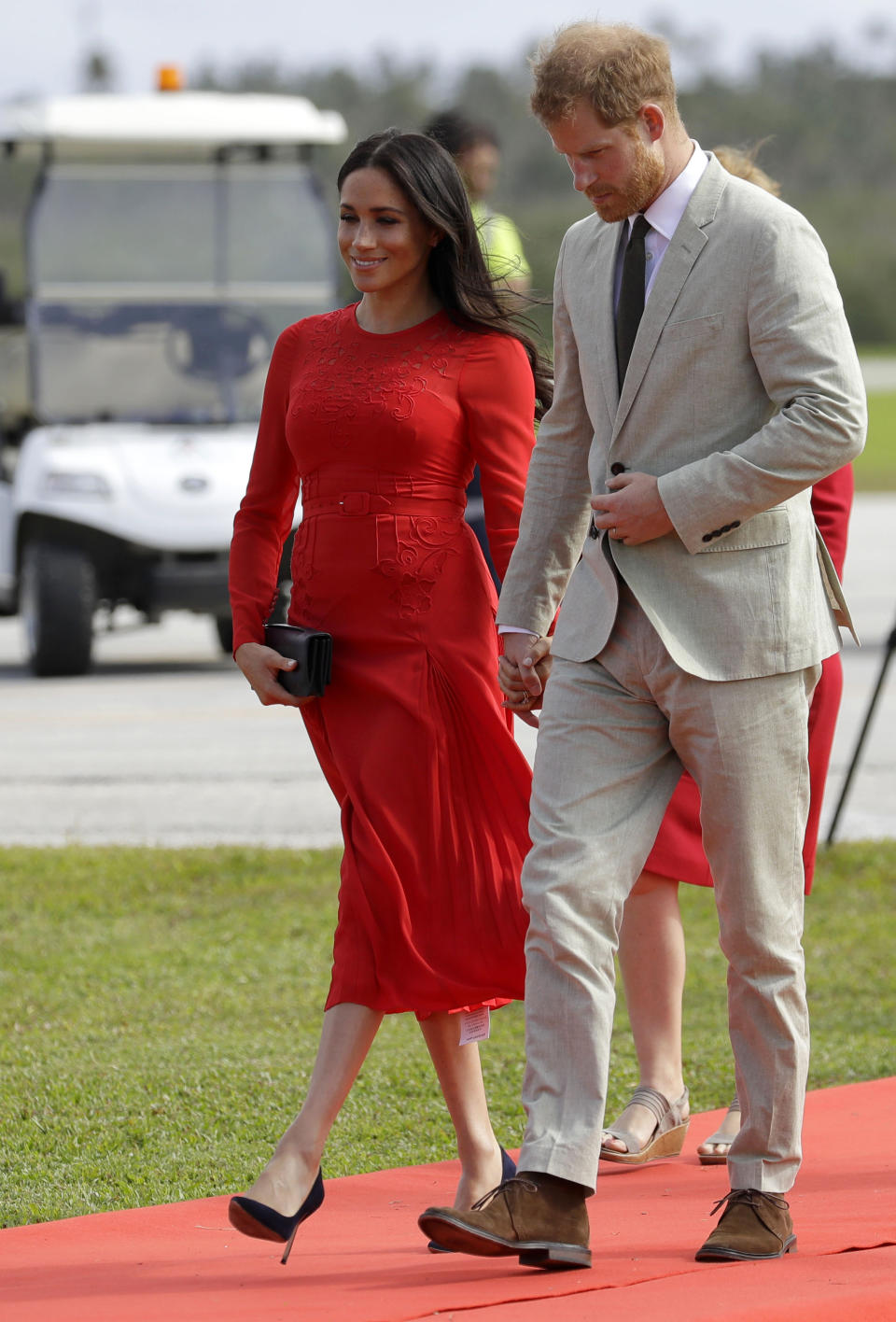 Britain's Prince Harry and Meghan, Duchess of Sussex arrive in Nuku'alofa,Tonga, Thursday, Oct. 25, 2018. Prince Harry and his wife Meghan are on day 10 of their 16-day tour of Australia and the South Pacific. (AP Photo/Kirsty Wigglesworth)