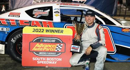 Layne Riggs with the trophy beside his No. 99 racer at South Boston Speedway