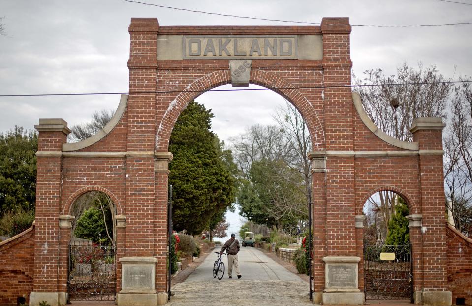 This photo taken Dec. 20, 2013 shows the entrance to the historic Oakland Cemetery in Atlanta. Some of the most famous residents are Margaret Mitchell and golf legend Bobby Jones, as well as rows and rows of Confederate soldiers. You can do a self-guided tour at any time, or guided overview tours and special topic twilight tours are available every weekend between mid-March and mid-October. (AP Photo/David Goldman)