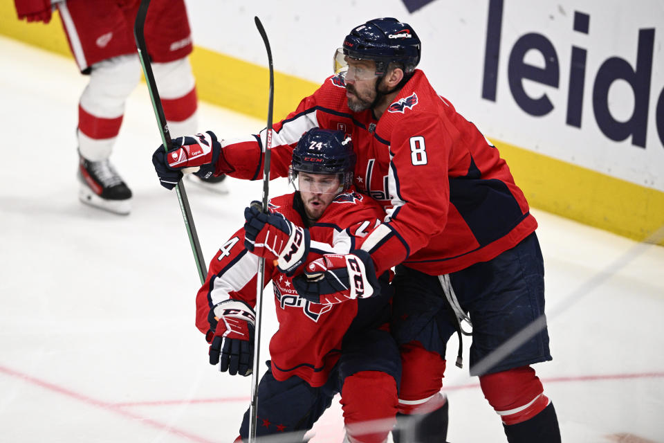 Washington Capitals center Connor McMichael (24) celebrates his goal with left wing Alex Ovechkin (8) during the third period of an NHL hockey game against the Detroit Red Wings, Tuesday, March 26, 2024, in Washington. The Capitals won 4-3 in overtime. (AP Photo/Nick Wass)