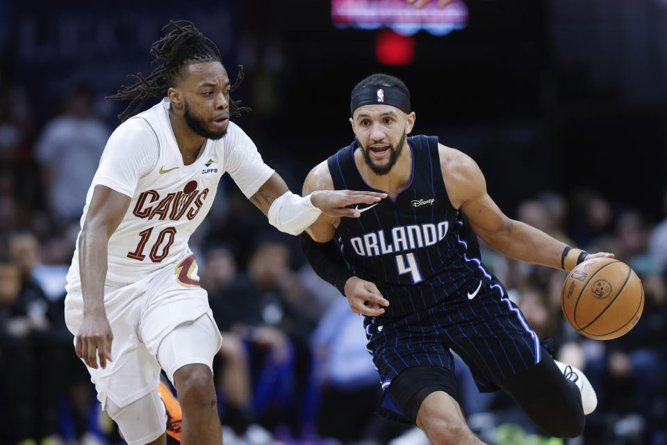 Orlando Magic guard Jalen Suggs (4) drives against Cleveland Cavaliers guard Darius Garland (10) during the second half of Game 2 of an NBA basketball first-round playoff series, Monday, April 22, 2024, in Cleveland. (AP Photo/Ron Schwane)