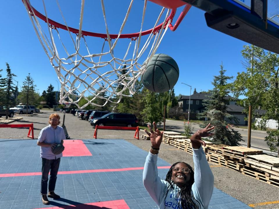 Estela Nadege plays bump with Adam Schwartz in the new public park outside the Christian Life Assembly church in Calgary's southwest. In bump, if the second player in line sinks the ball before the first player, the first player is eliminated.