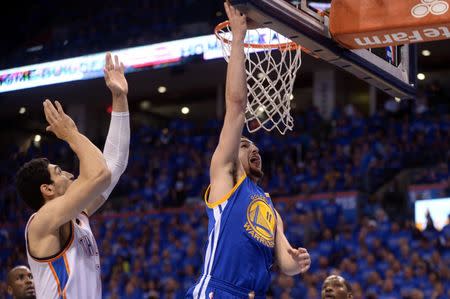 May 28, 2016; Oklahoma City, OK, USA; Golden State Warriors guard Klay Thompson (11) shoots a layup in font of Oklahoma City Thunder center Enes Kanter (11) during the third quarter in game six of the Western conference finals of the NBA Playoffs at Chesapeake Energy Arena. Mandatory Credit: Mark D. Smith-USA TODAY Sports