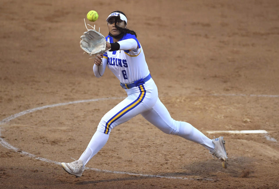 Starting pitcher Megan Faraimo of UCLA Bruins fields a ball and throws out Jayme Bailey of Virginia Tech at first base in the fourth inning of game two of the NCAA Softball Super Regional Game on Easton Field on the campus of UCLA in Westwood on Friday, May 28, 2021. (Keith Birmingham/The Orange County Register via AP)