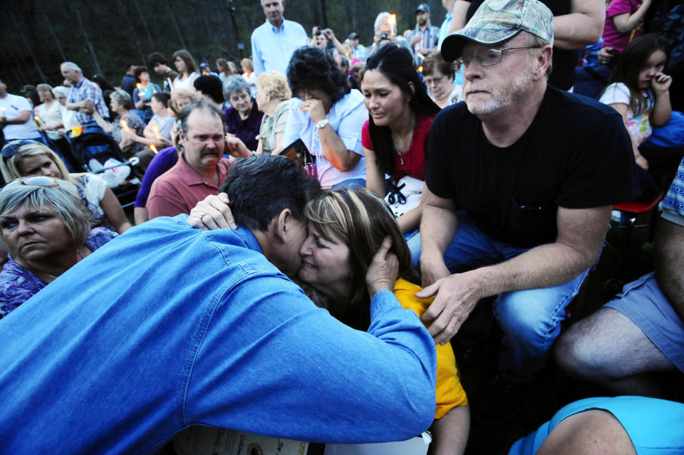 FILE - Gov. Joe Manchin, left, gives a hug to Pam Napper the mother of deceased coal miner Josh Napper, along with his father Scott Napper, top, and girlfriend Jennifer Ziegler, in red, Wednesday, April 7, 2010 at a candlelight vigil in Cabin Creek, W.Va. Manchin announced Thursday, Nov. 9, 2023, that he is not seeking reelection to the U.S. Senate in 2024. (AP Photo/Jeff Gentner, File)